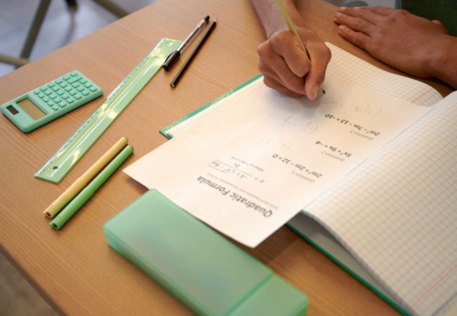 A pencil resting on a partially completed math worksheet